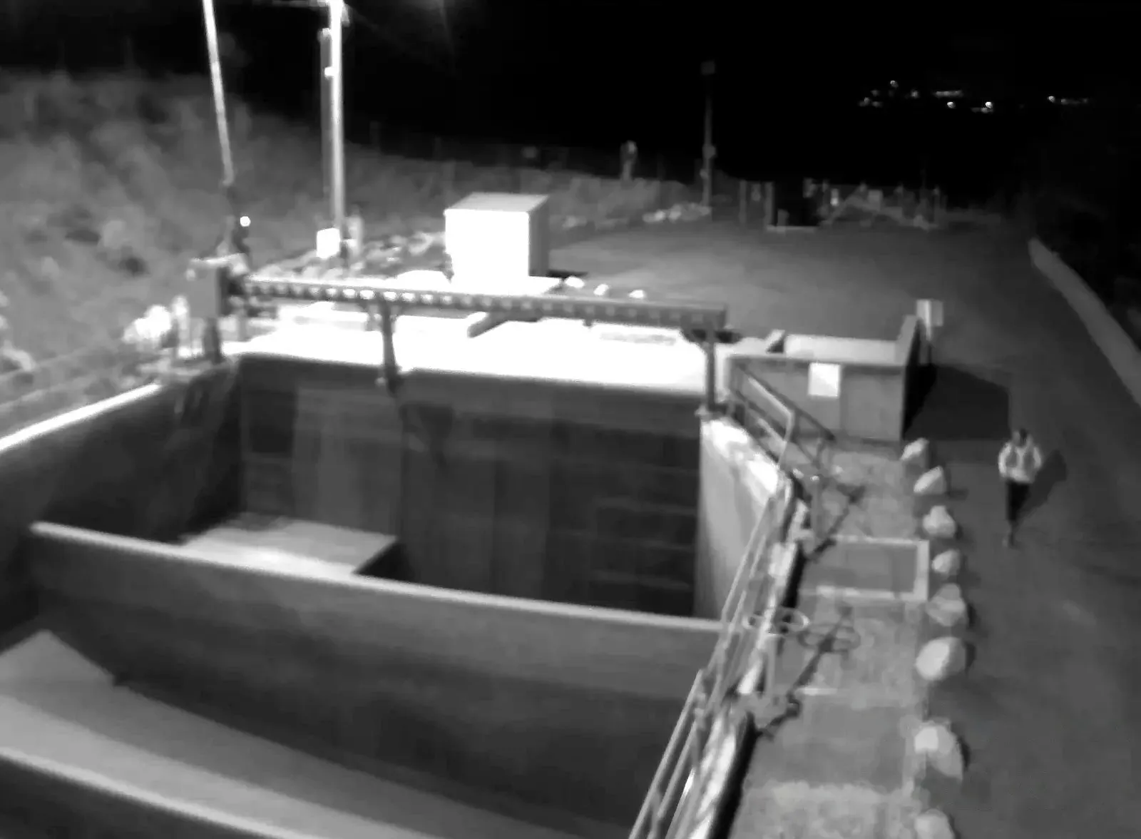 Night infrared camera view with a person detected on a walkway
